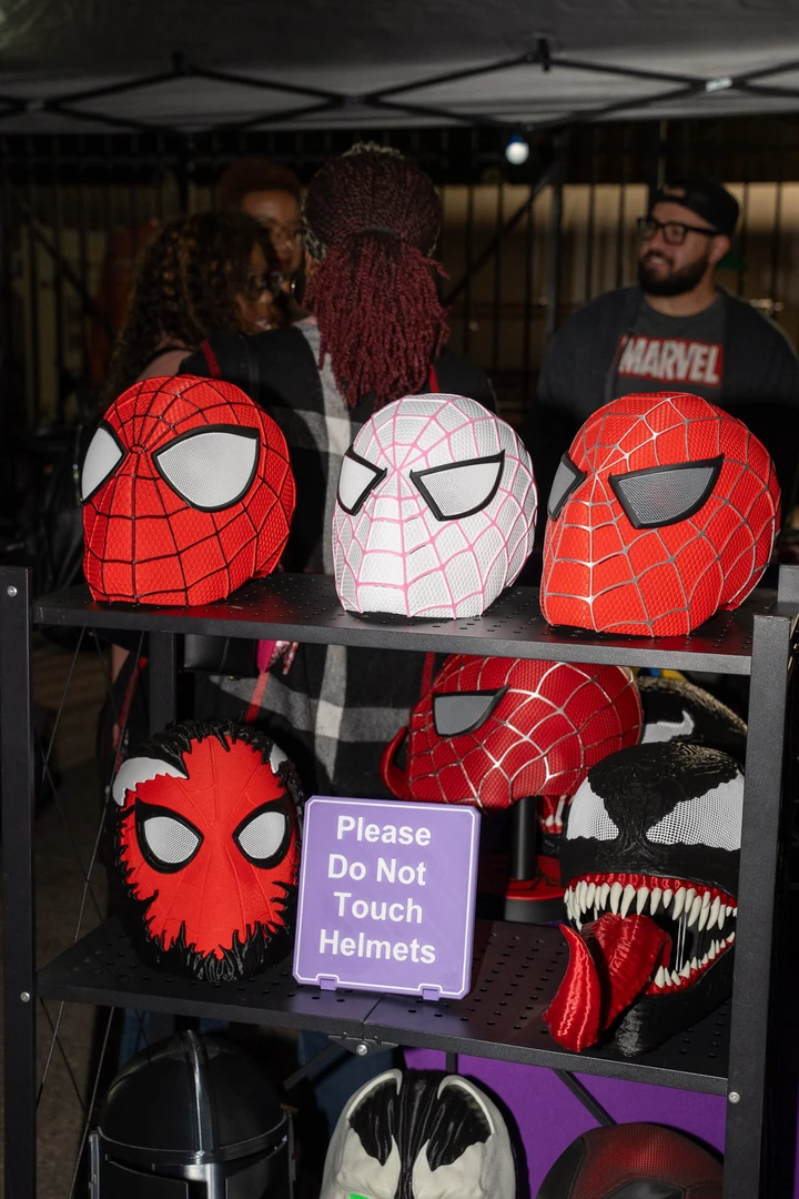 Superhero-themed bags hanging from a market display.