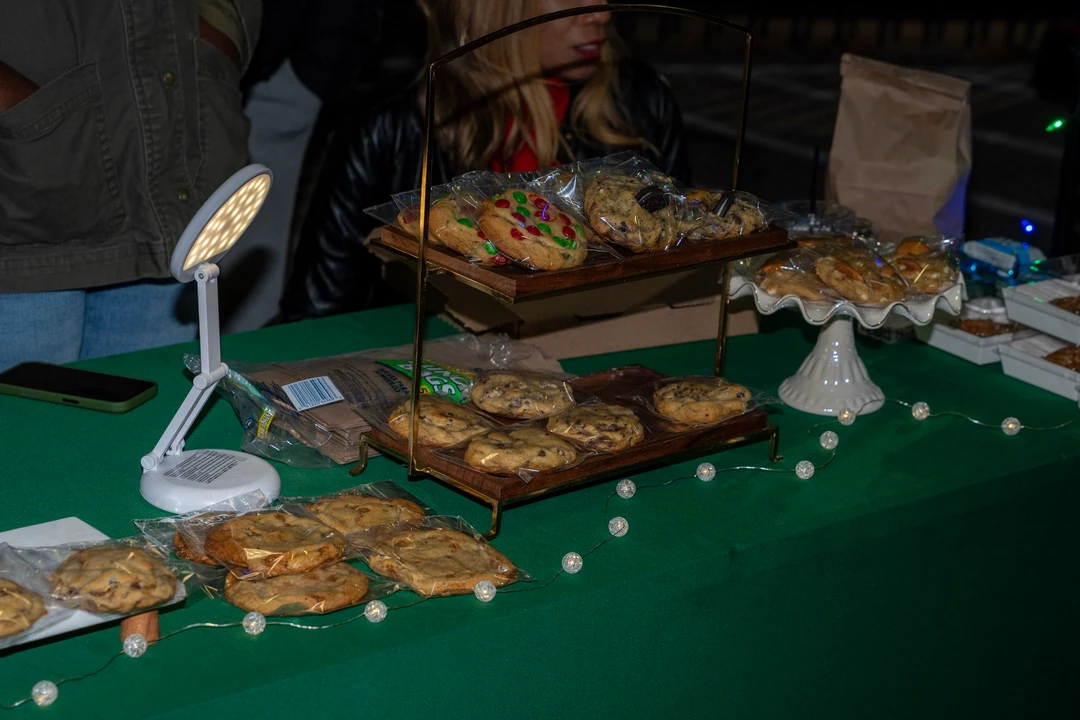 Cookies and other baked goods arranged on a green tablecloth.