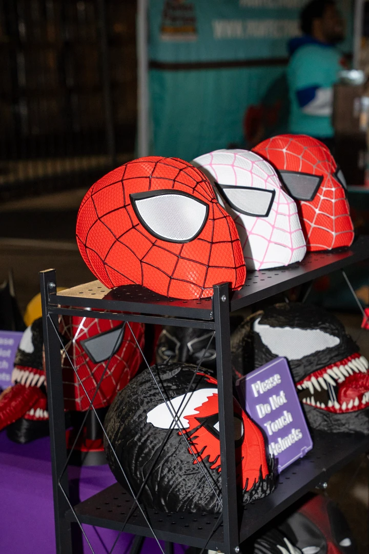 Colorful superhero-themed bags on a market display.