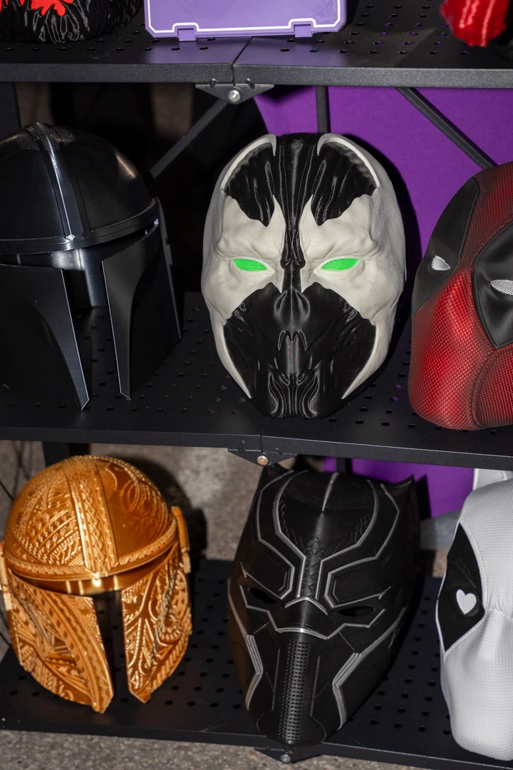 Colorful superhero-themed bags on a market display.