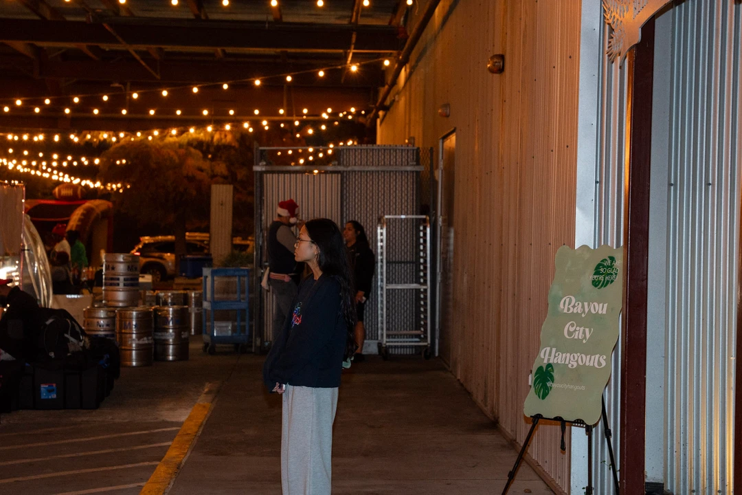 Visitors walking through the illuminated evening market.