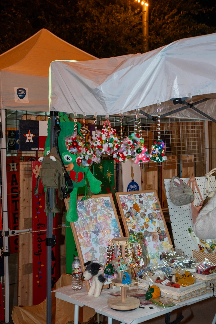 Hanging ornaments and colorful small gifts at a market stall.