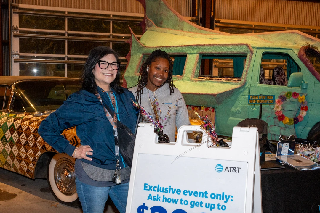 Two vendors posing beside an AT&T display.