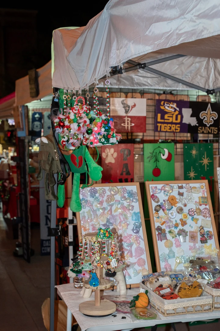 Hanging ornaments and handmade accessories filling a colorful stall.