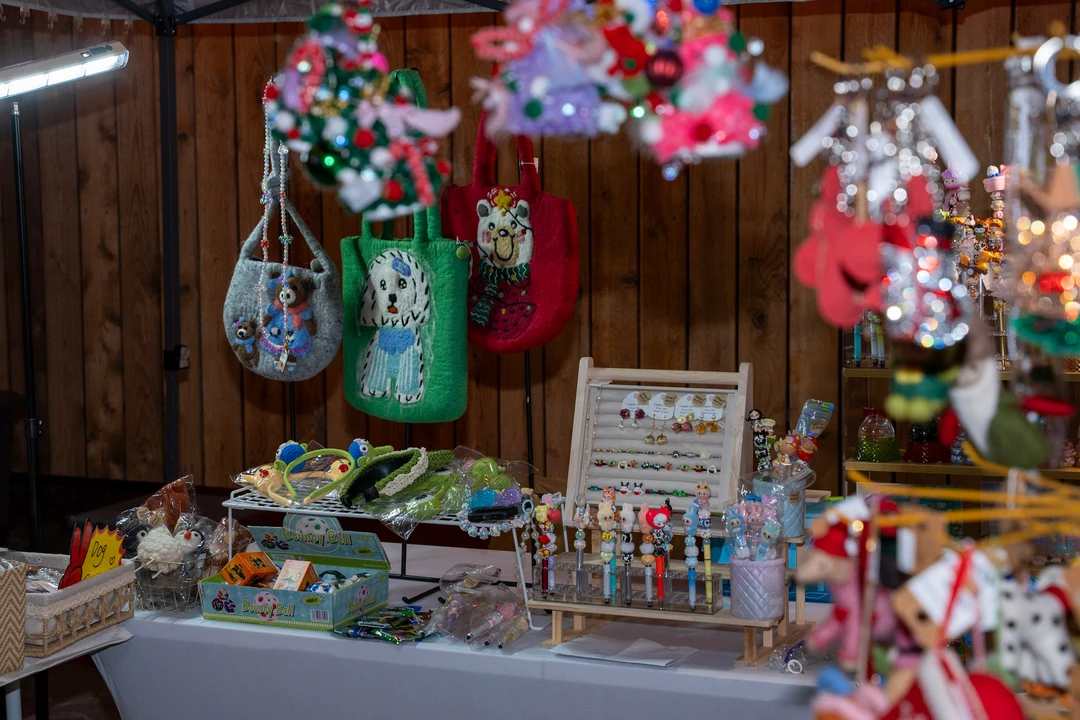 Hanging ornaments and handmade accessories filling a colorful stall.
