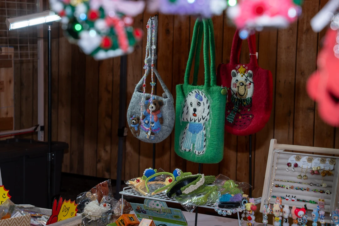 Hanging ornaments and handmade accessories filling a colorful stall.