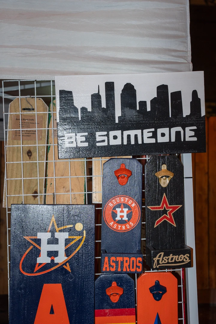 Printed Houston-themed signs displayed at a market stall.