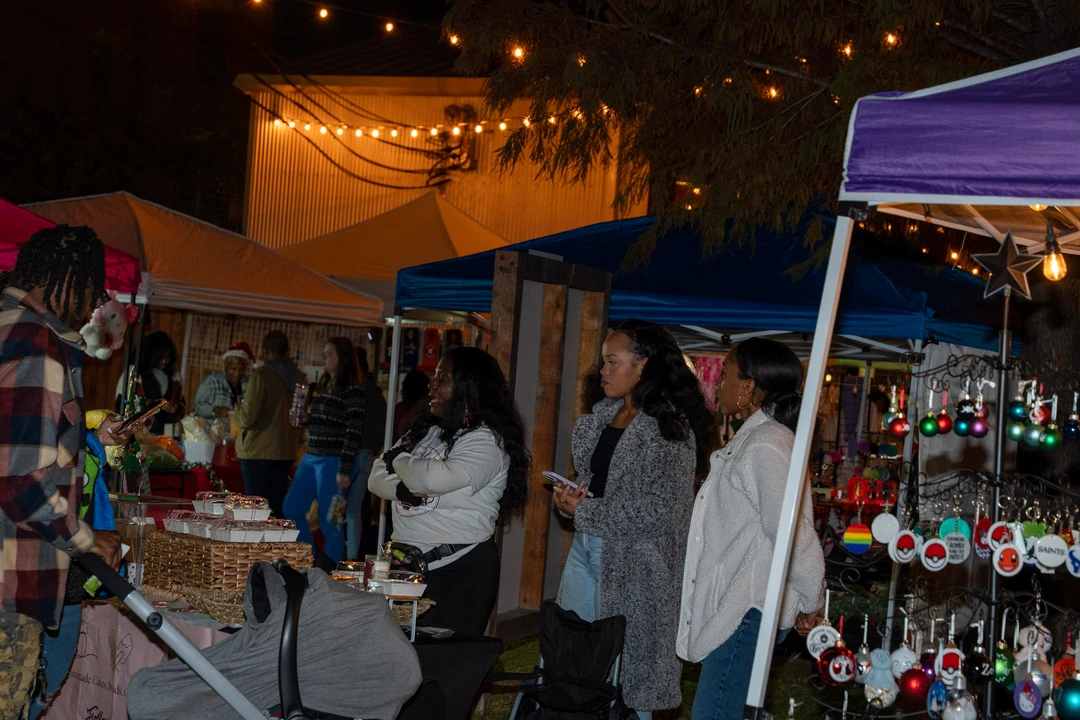 Friends gathering at an outdoor market table after dark.