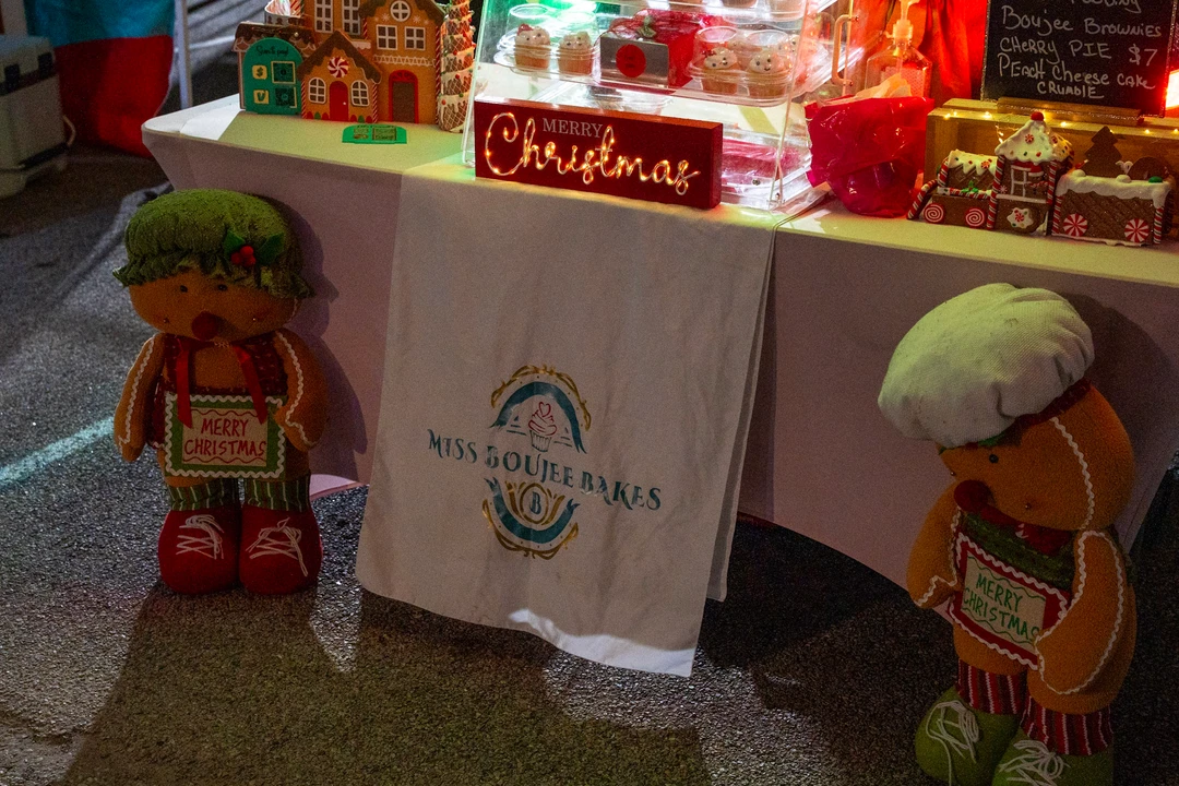 Festive figures and decorations beside a holiday display.