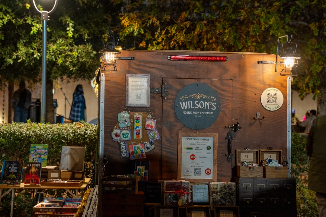 The mobile bookshop and its painted signs after dark.