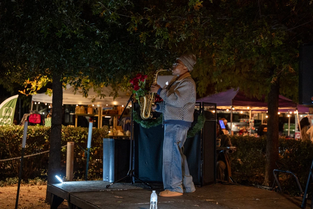 Two musicians performing beside the evening market.