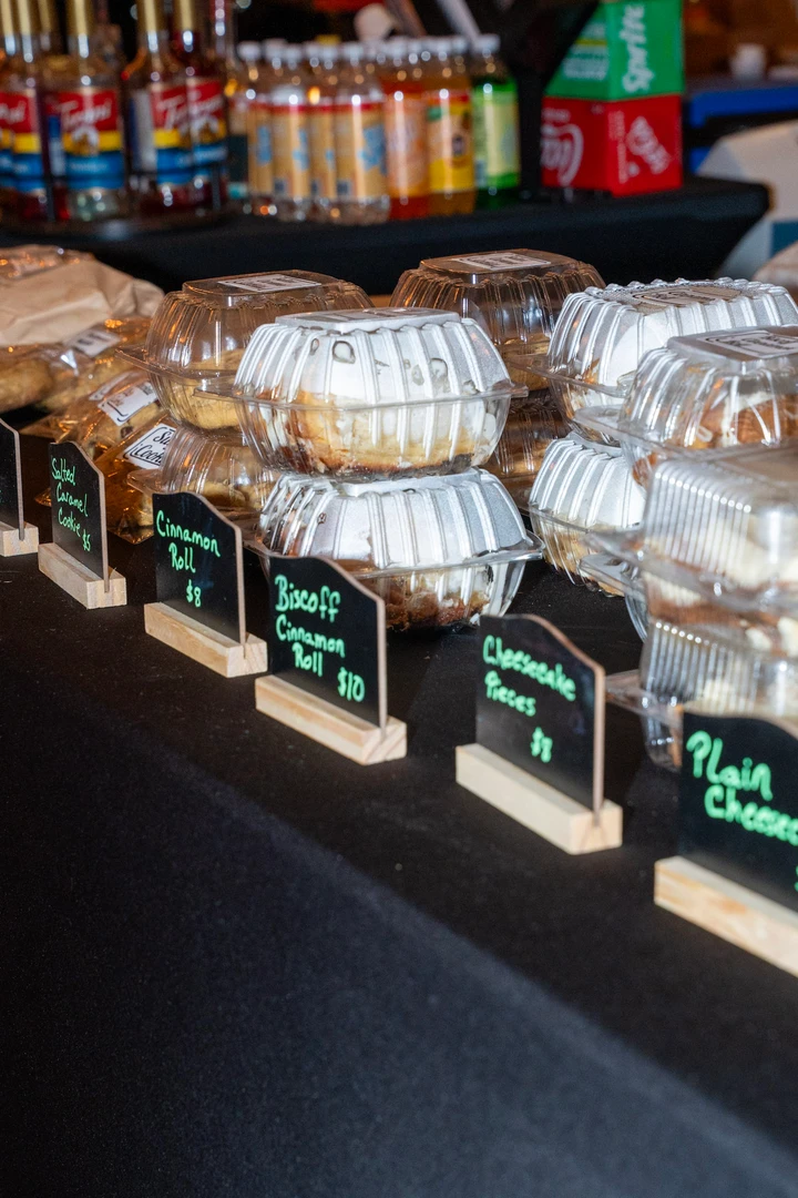 Packaged baked goods arranged in rows on a dark table.