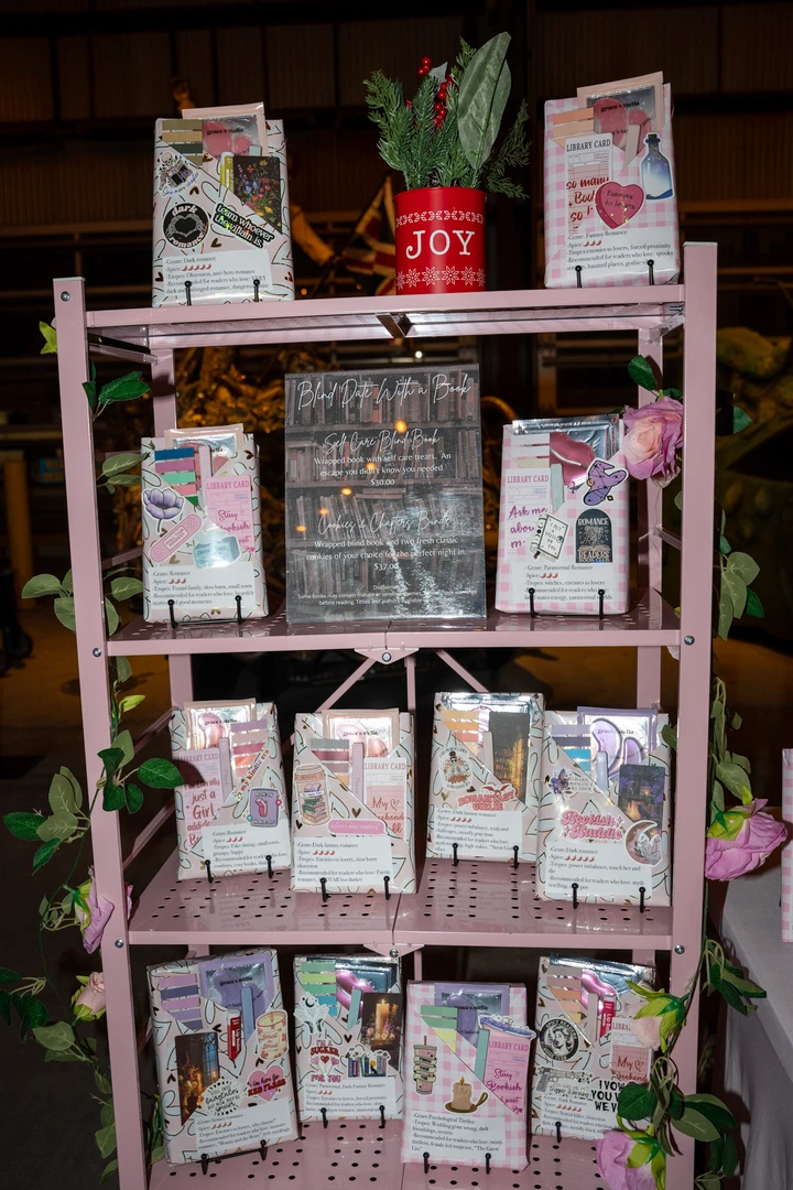 Small gifts and packages on a wooden market shelf.