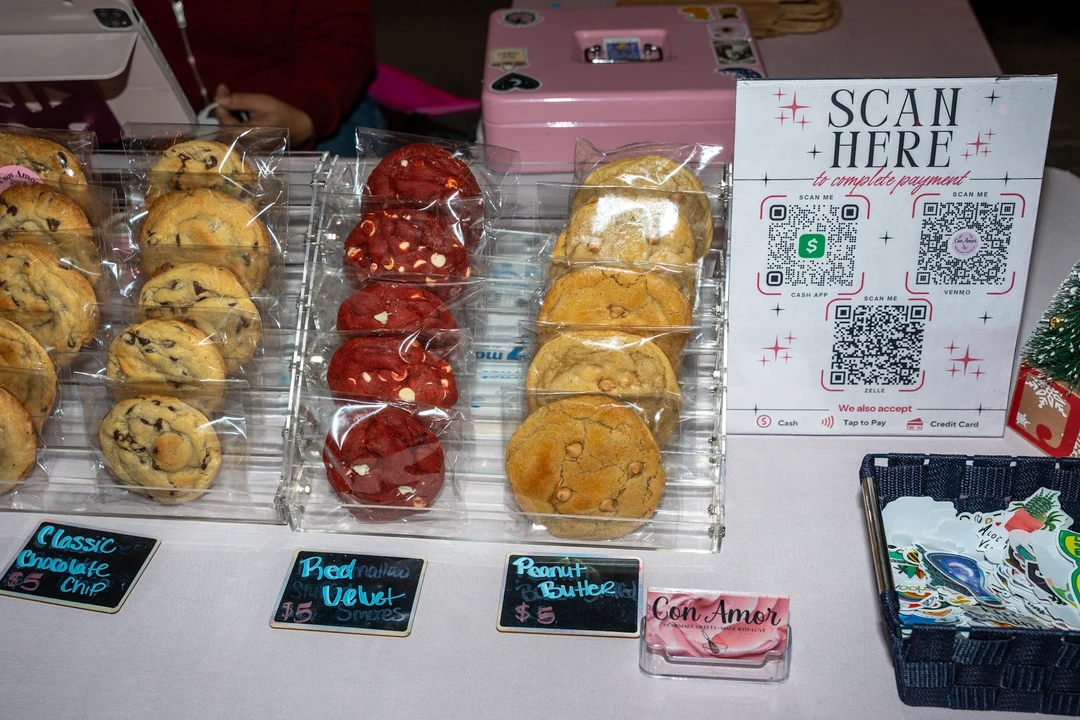Packaged baked goods and handwritten labels on a display table.