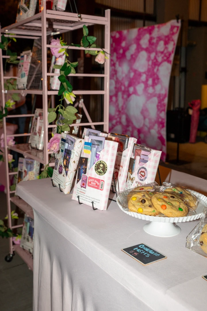 Small packages and printed cards at a holiday market stall.