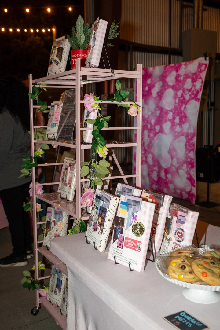 Small packages and printed cards at a holiday market stall.