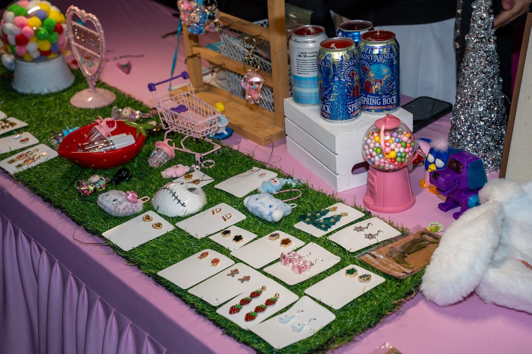 Handmade jewelry displayed on a pink tablecloth.