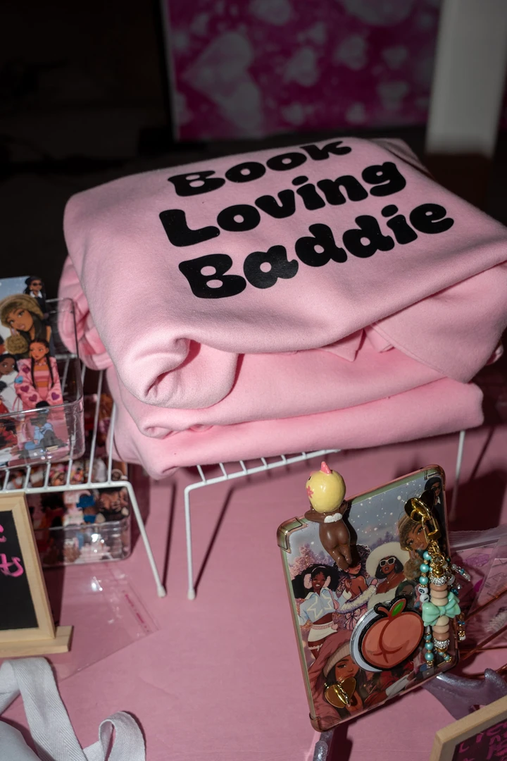 A pink Locally Sourced Baddie shirt on a display.