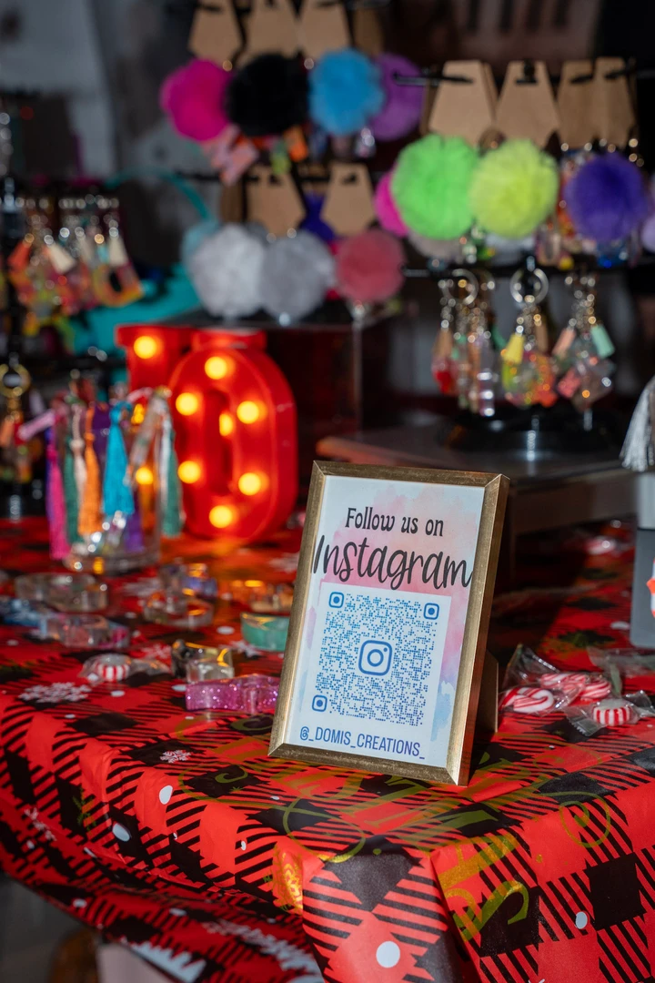 Colorful crocheted flowers and festive decorations at a stall.