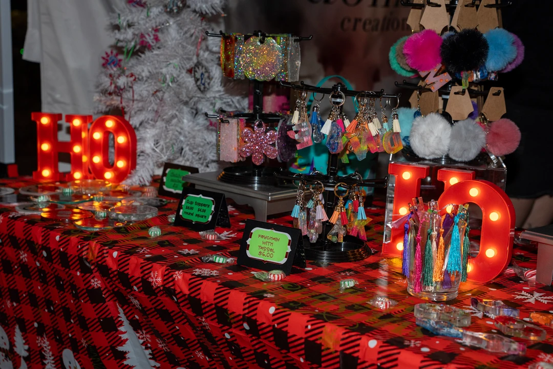 Colorful crocheted flowers and festive decorations at a stall.