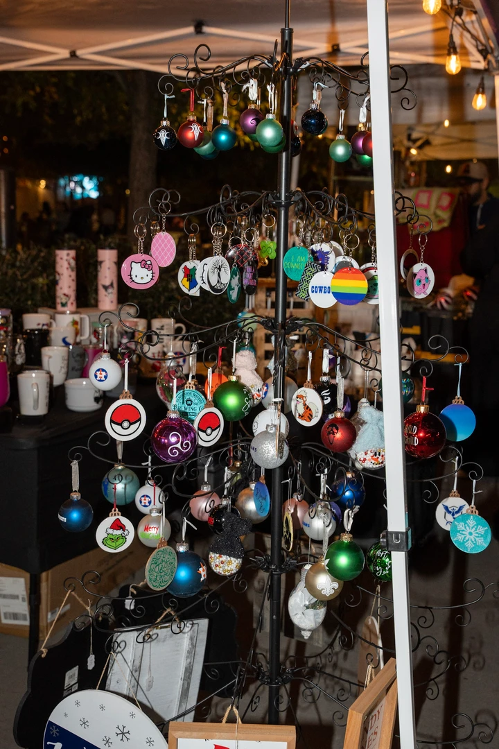 Candles and gifts arranged on a tiered outdoor display.