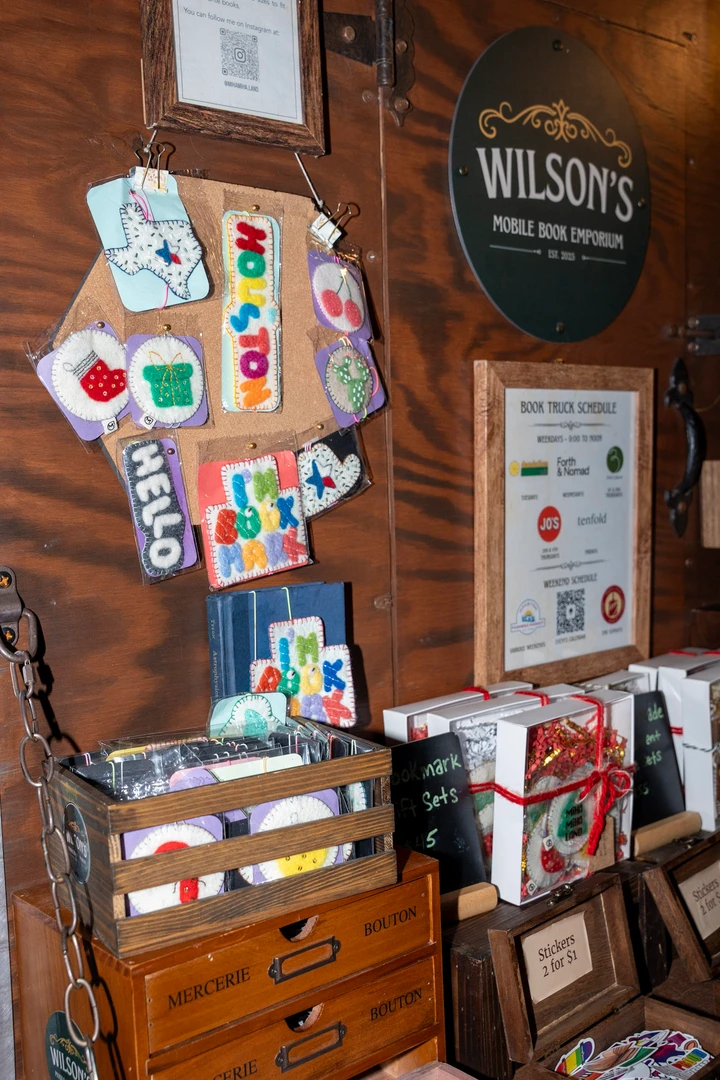 Bookshop signs and decorations beside outdoor shelves.