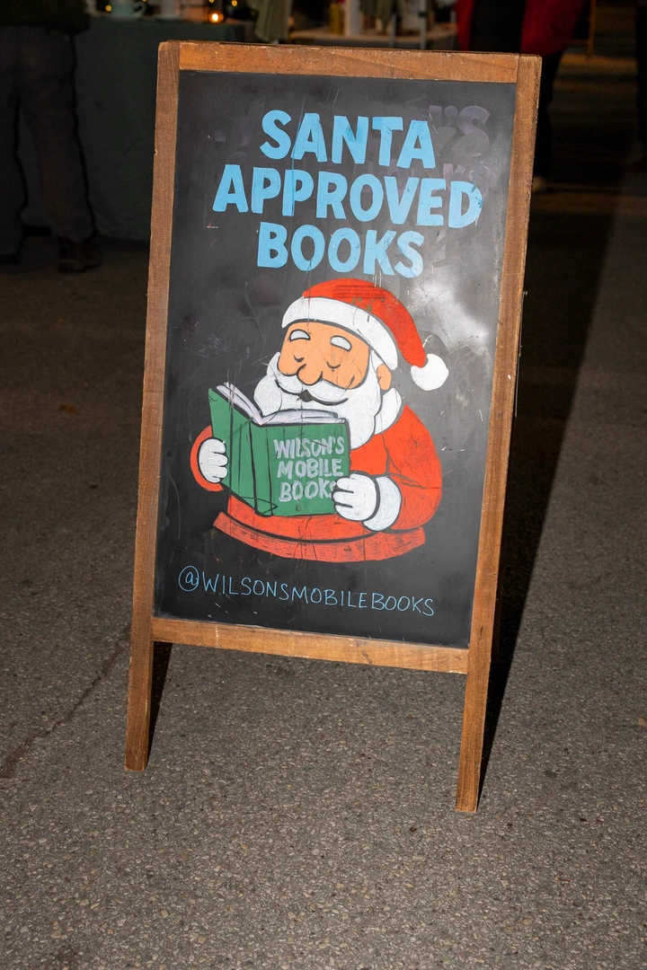 Bookshop signs and decorations beside outdoor shelves.