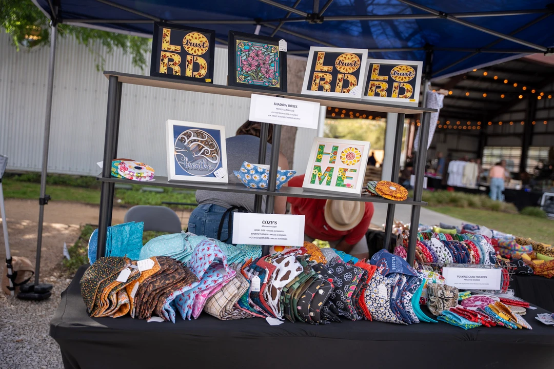 Crafts and framed designs arranged beneath a blue canopy.
