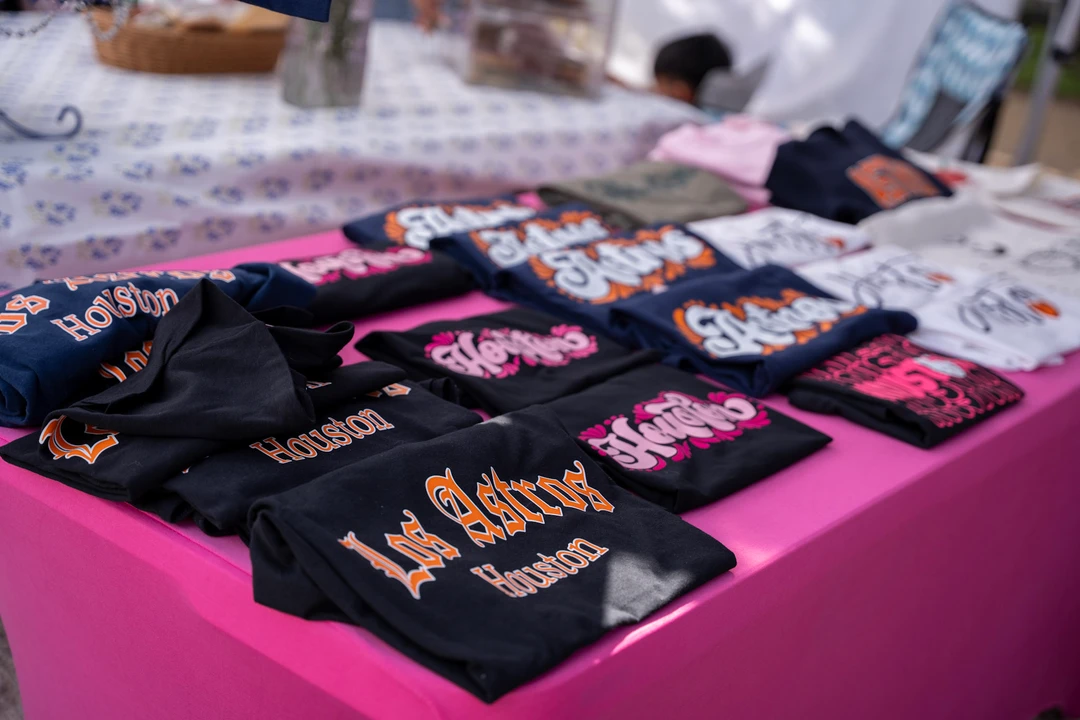 Printed fabric items laid out on a pink table.