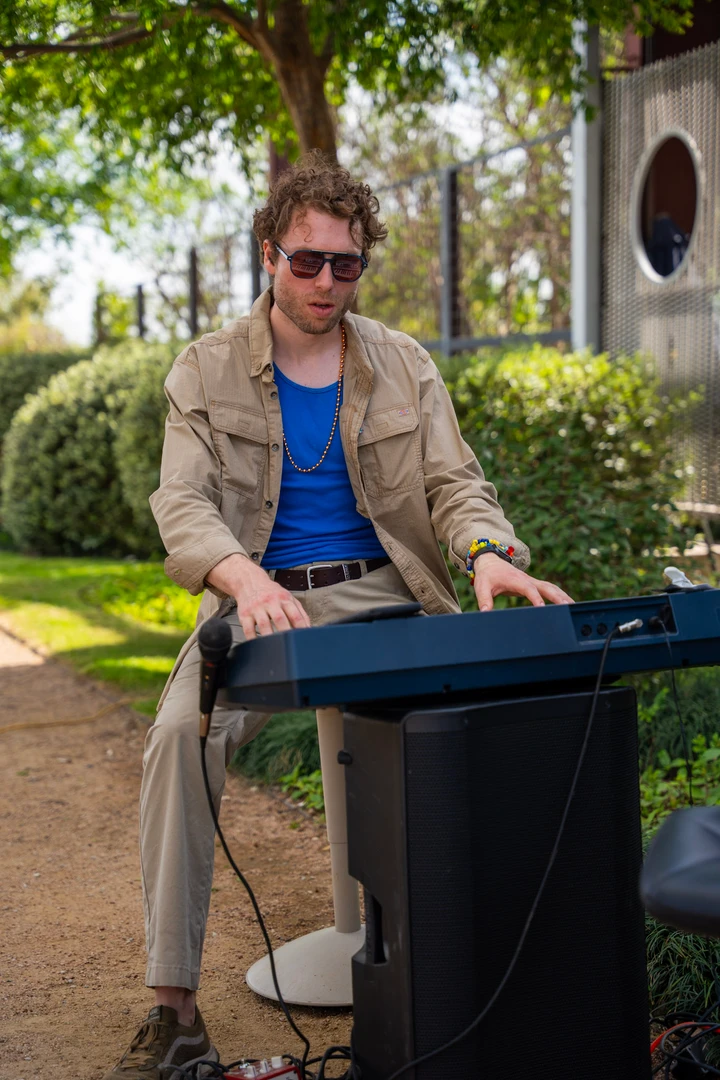 A musician playing a keyboard outside.