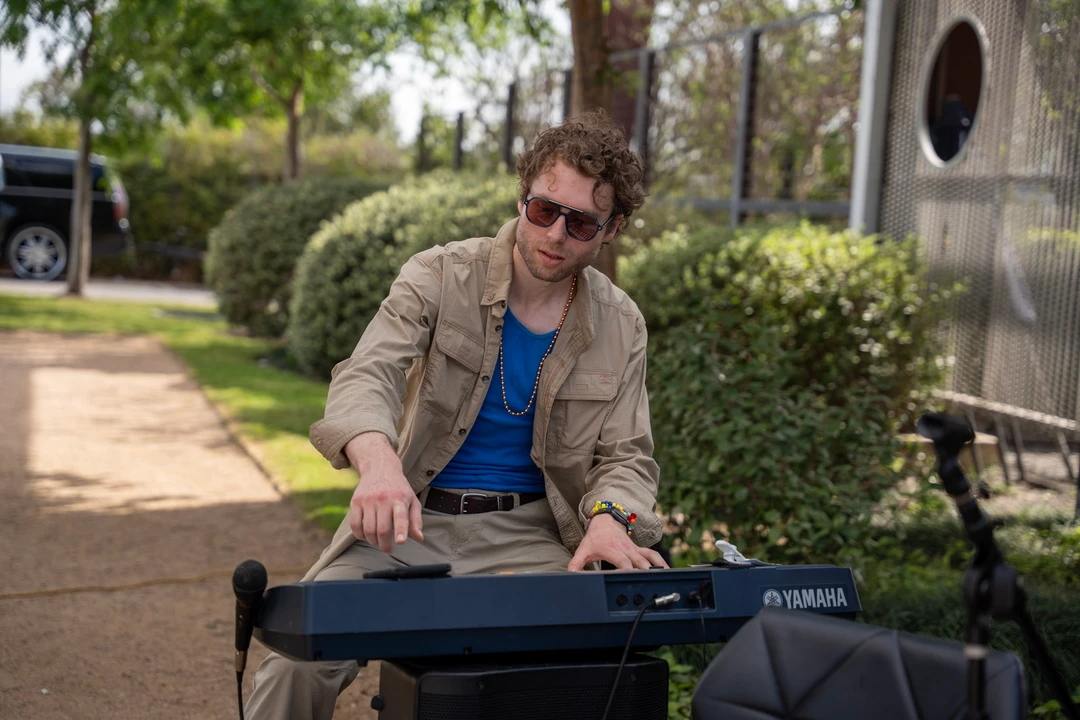 A musician playing a keyboard outside.