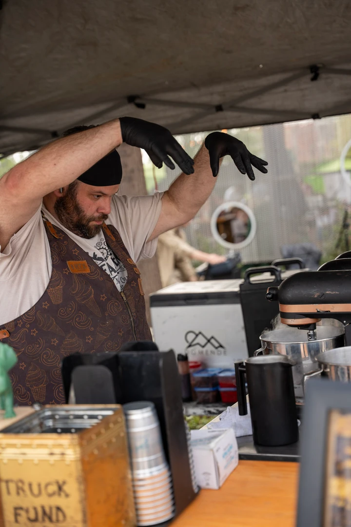 A vendor preparing a drink behind a counter.