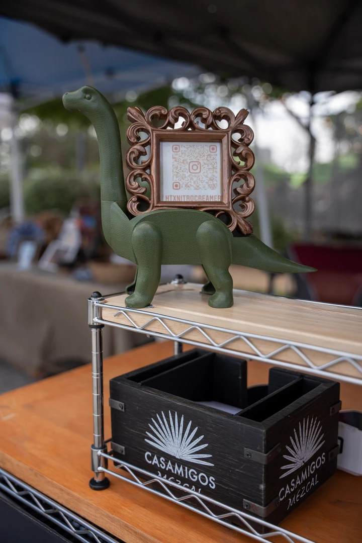 A small decorative mirror above a tabletop display.