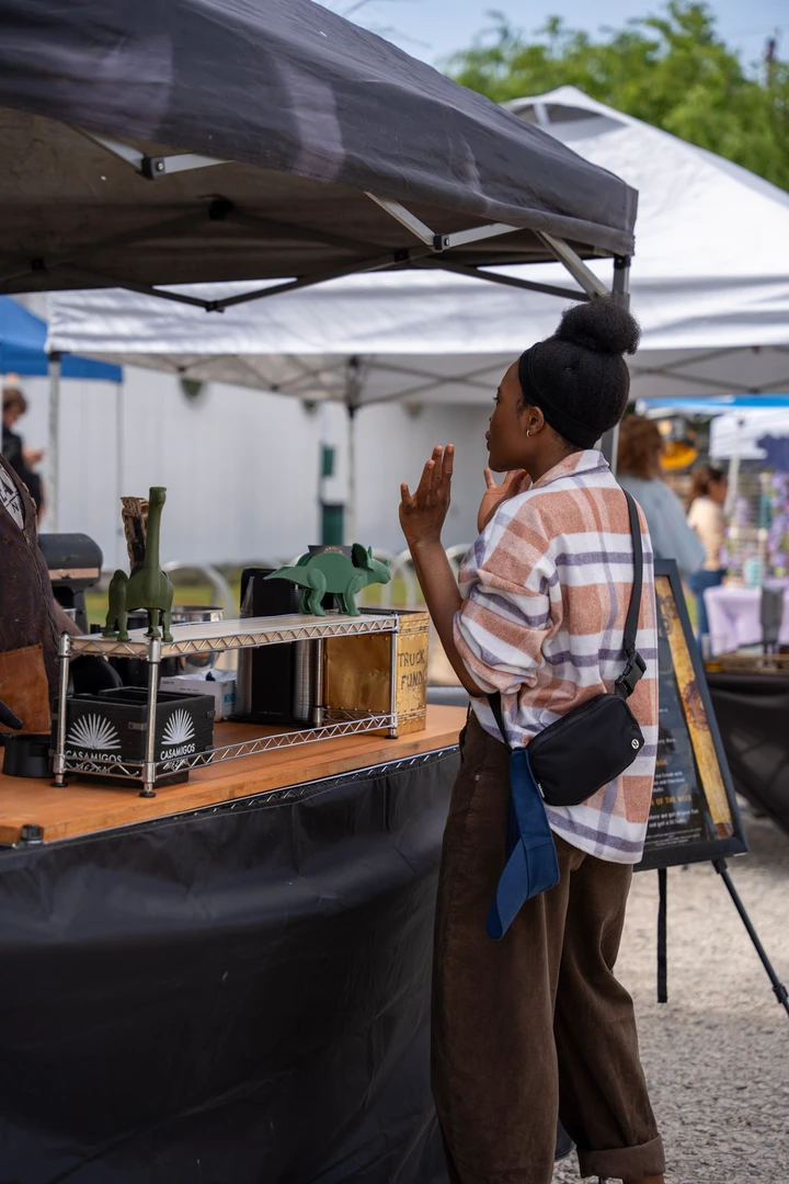 A vendor beside an outdoor drinks stall.