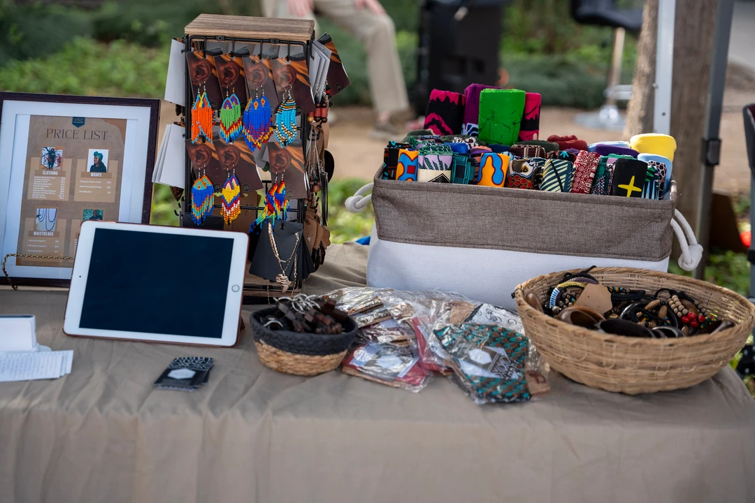 Colorful crafts and small framed pieces arranged on a table.