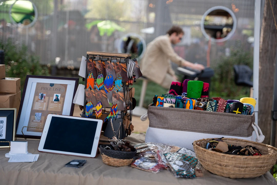 Colorful crafts and small framed pieces arranged on a table.