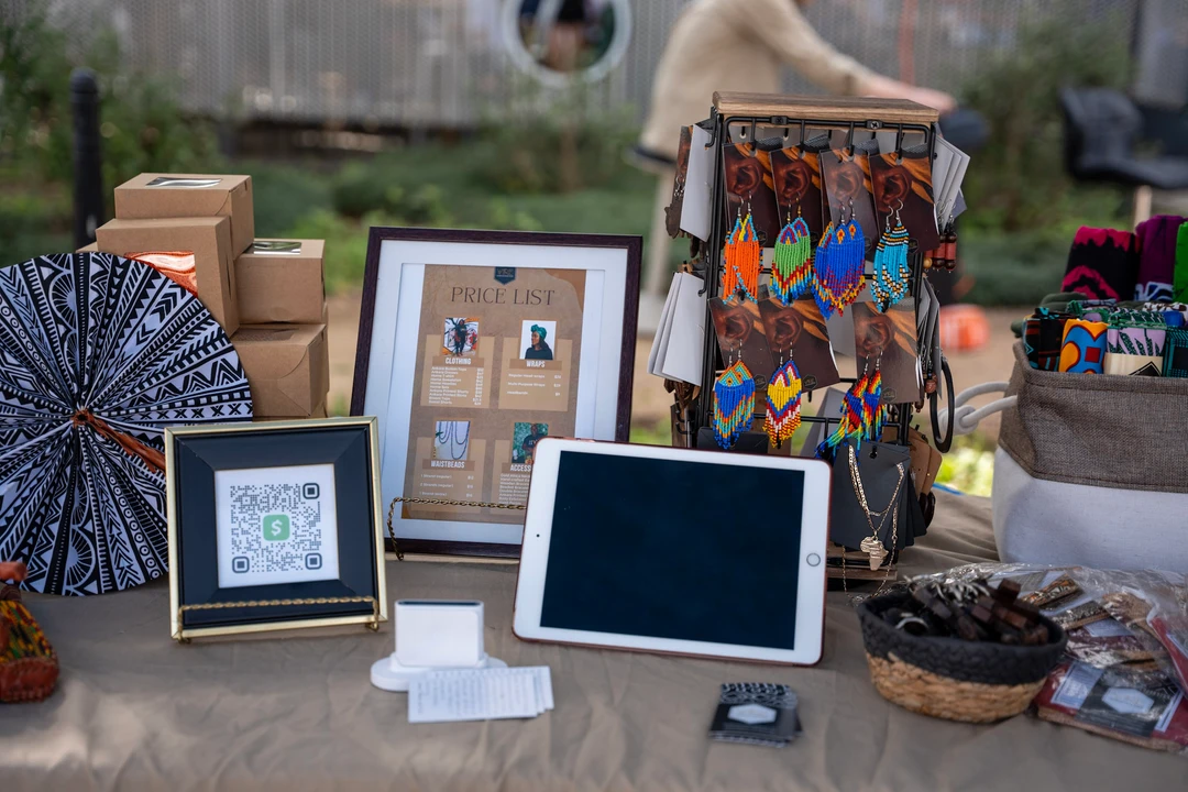 Colorful crafts and small framed pieces arranged on a table.