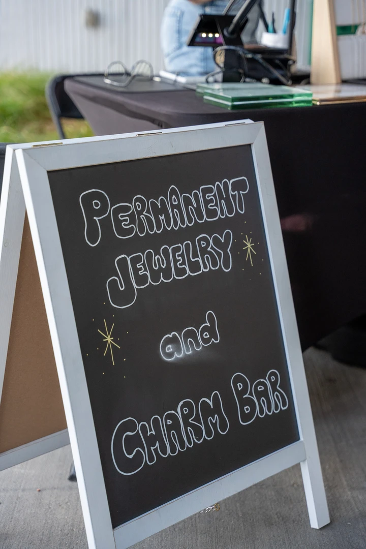 A permanent jewelry and charm bar chalkboard.
