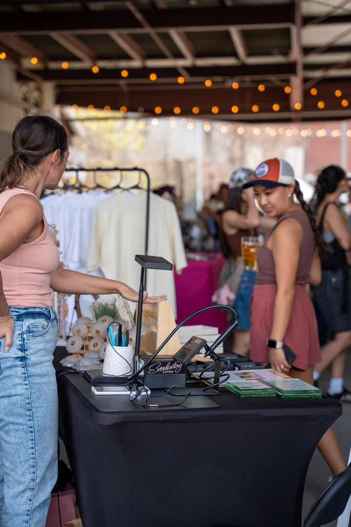 Shoppers gathered around an indoor jewelry stall.