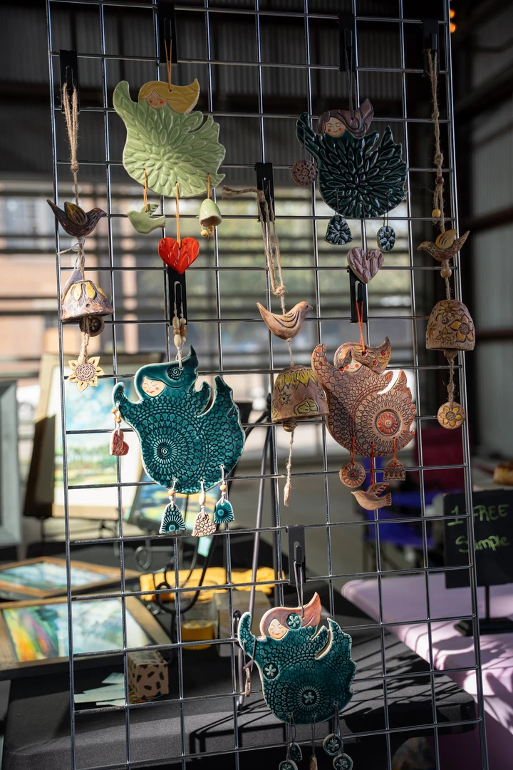 Handmade hanging ornaments on a wire display.