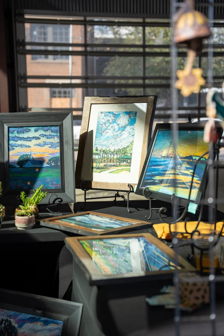 Framed artwork displayed beside the market windows.