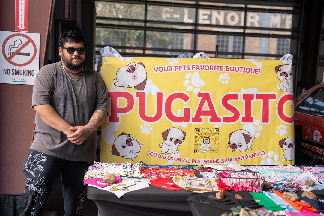 A vendor beside a colorful Pugasito banner.
