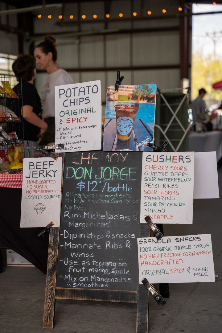 Handwritten food menus beside a snack display.