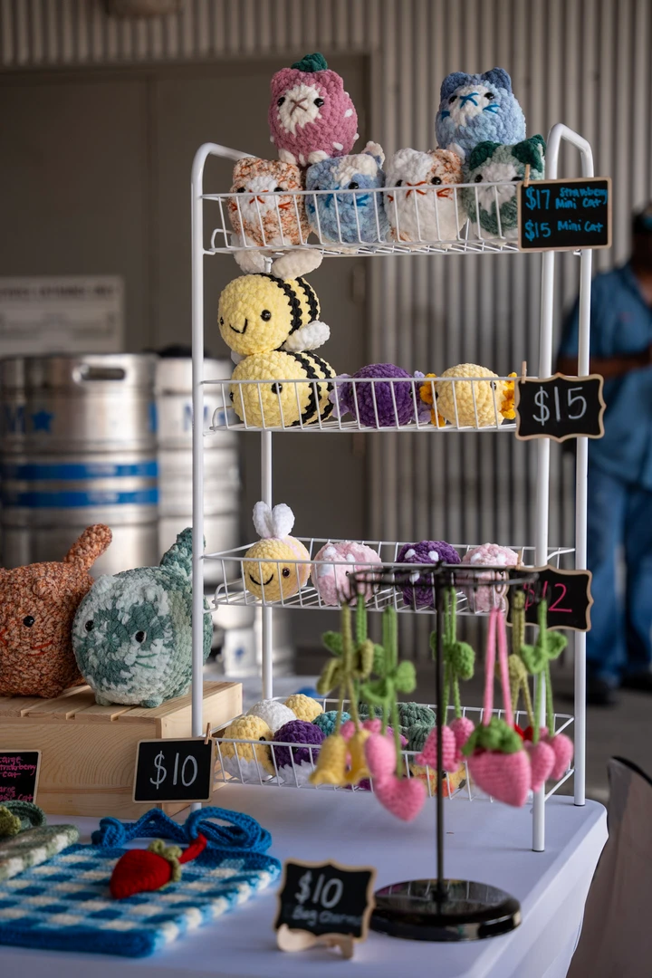 Small colorful products arranged on a vendor table.