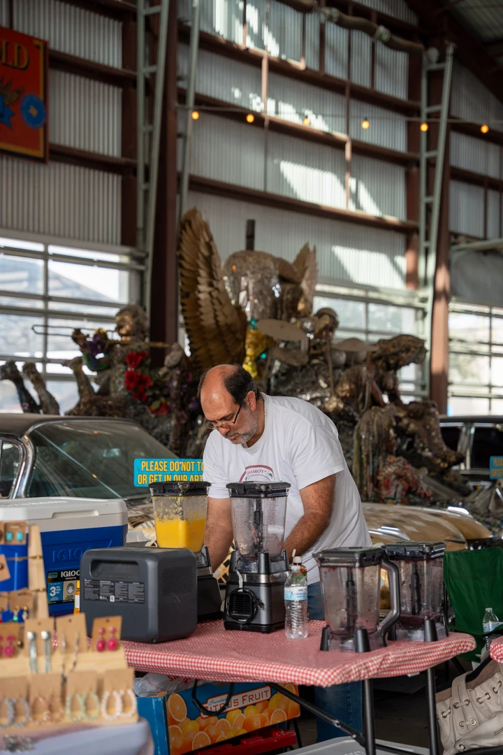 A maker working behind a table of small products.