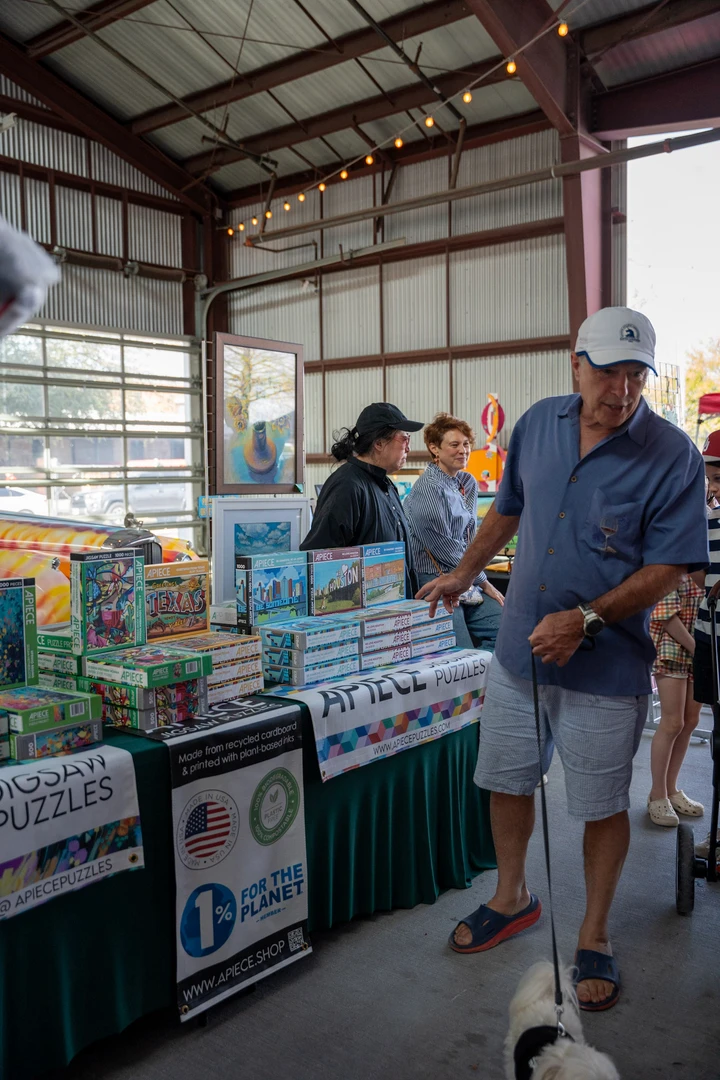 A visitor beside an indoor vendor display.