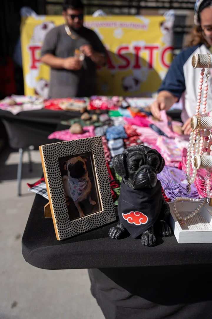 Framed pieces and colorful accessories on a market table.